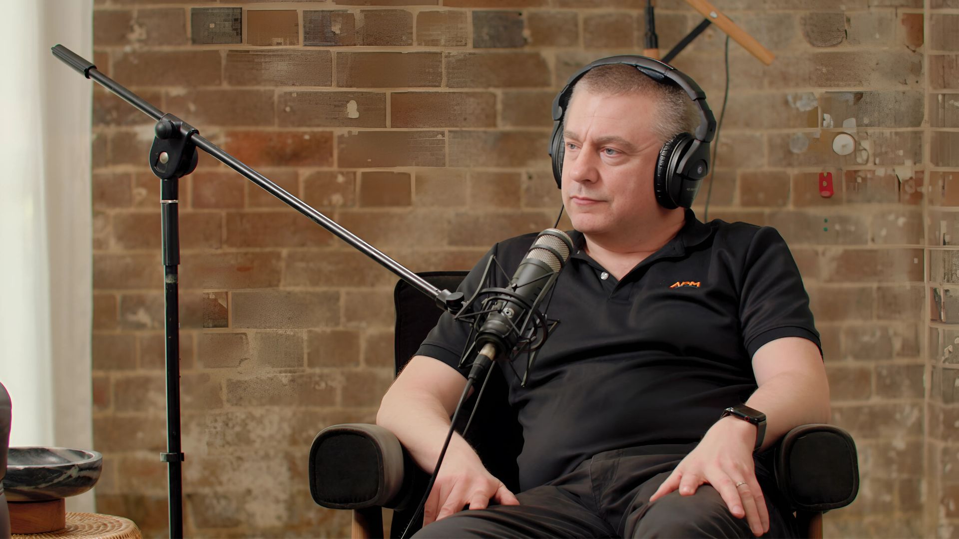 APM manager Graham in a black top speaking into a microphone